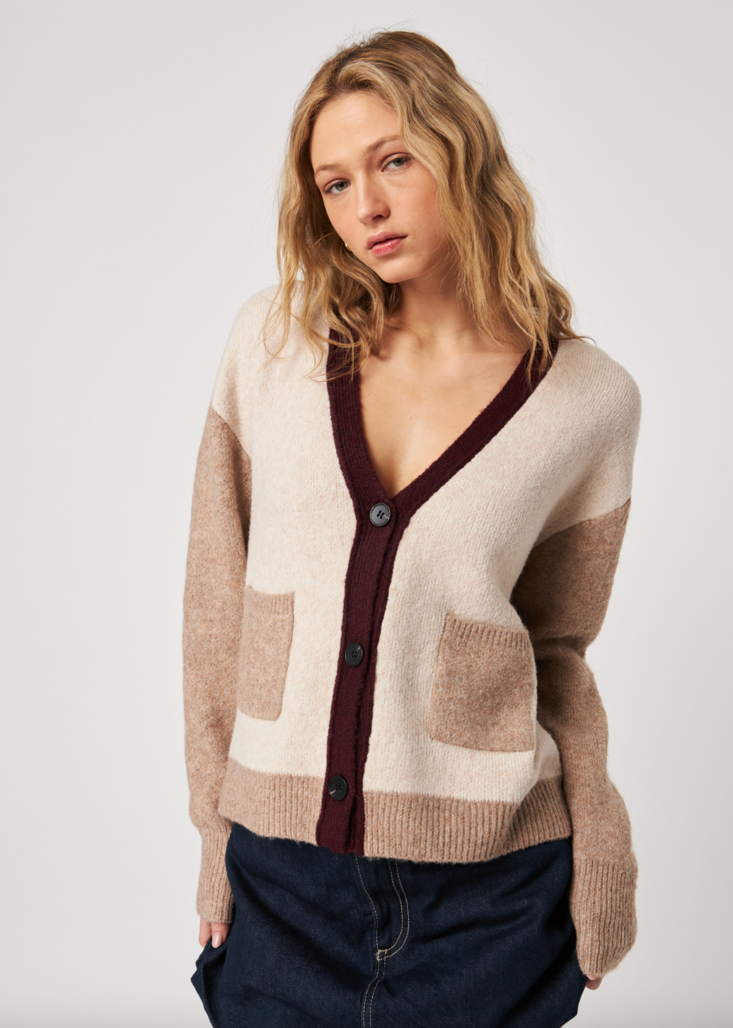 Woman wearing a patterned cardigan on a plain background — alternate view
